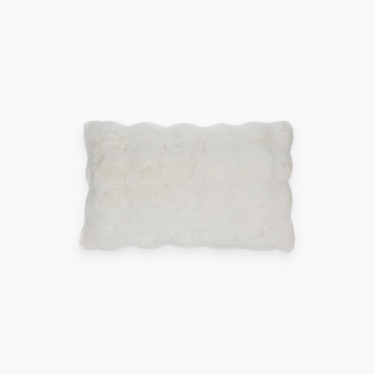 Lyckåsen Misty ivory rectangular faux fur cushion with a soft, fluffy texture for a cozy home decor accent.