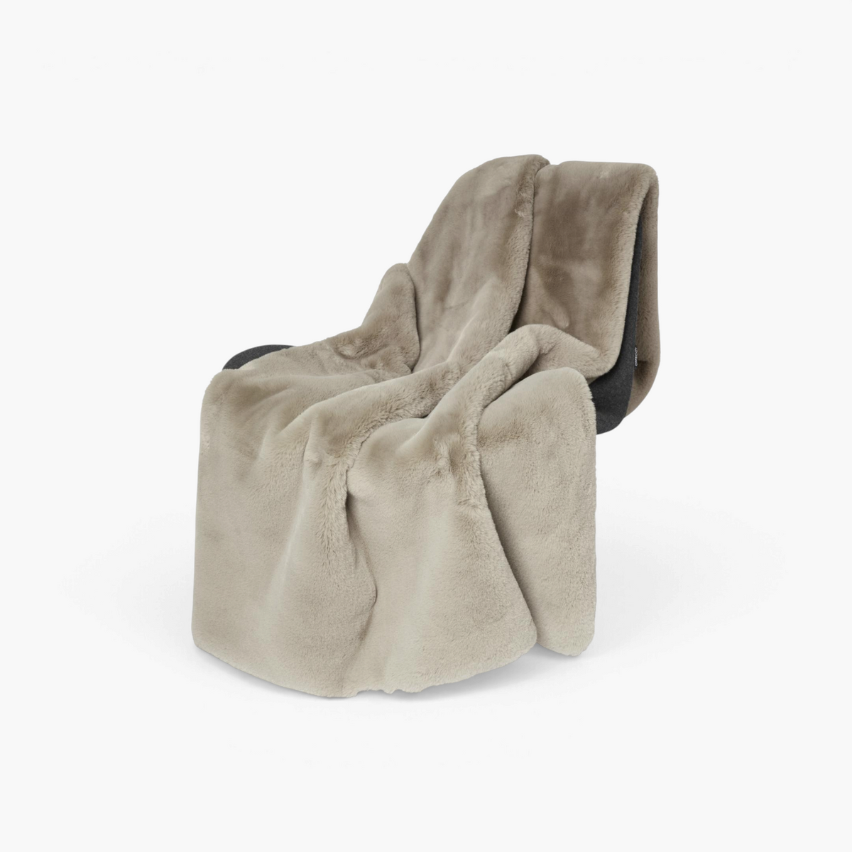 Lyckåsen Fluffy faux fur blanket in nougat brown draped over a chair, featuring a thick, silky, plush texture.