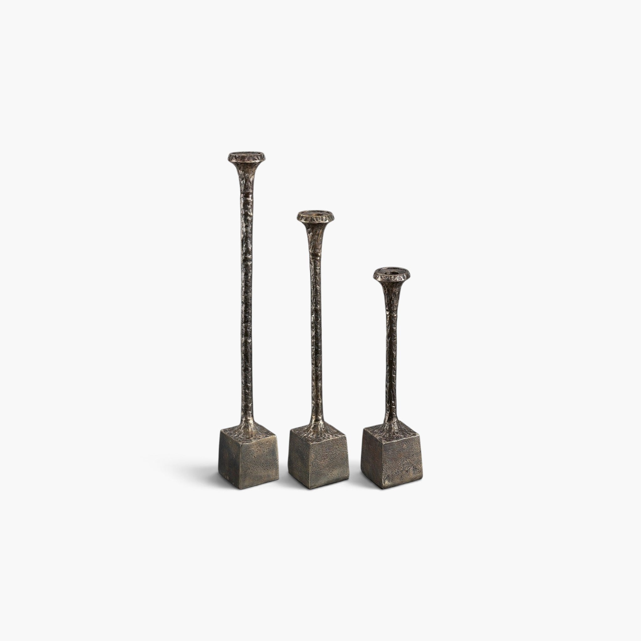 Lyckåsen set of 3 antique brass metal candlesticks with a textured hammered finish and square bases.