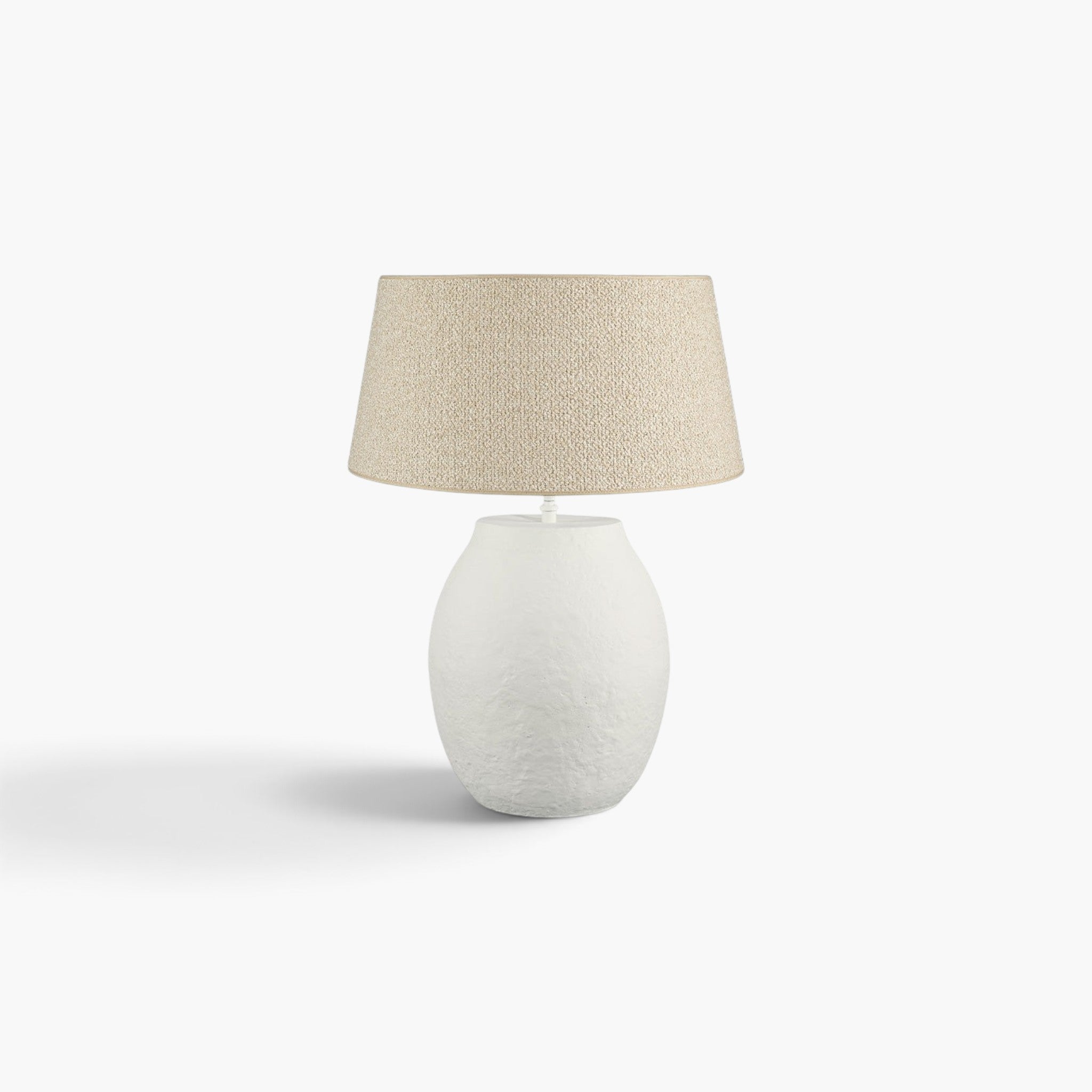Lyckåsen Fiora ivory metal table lamp with a textured finish and a beige fabric lampshade on a white background.