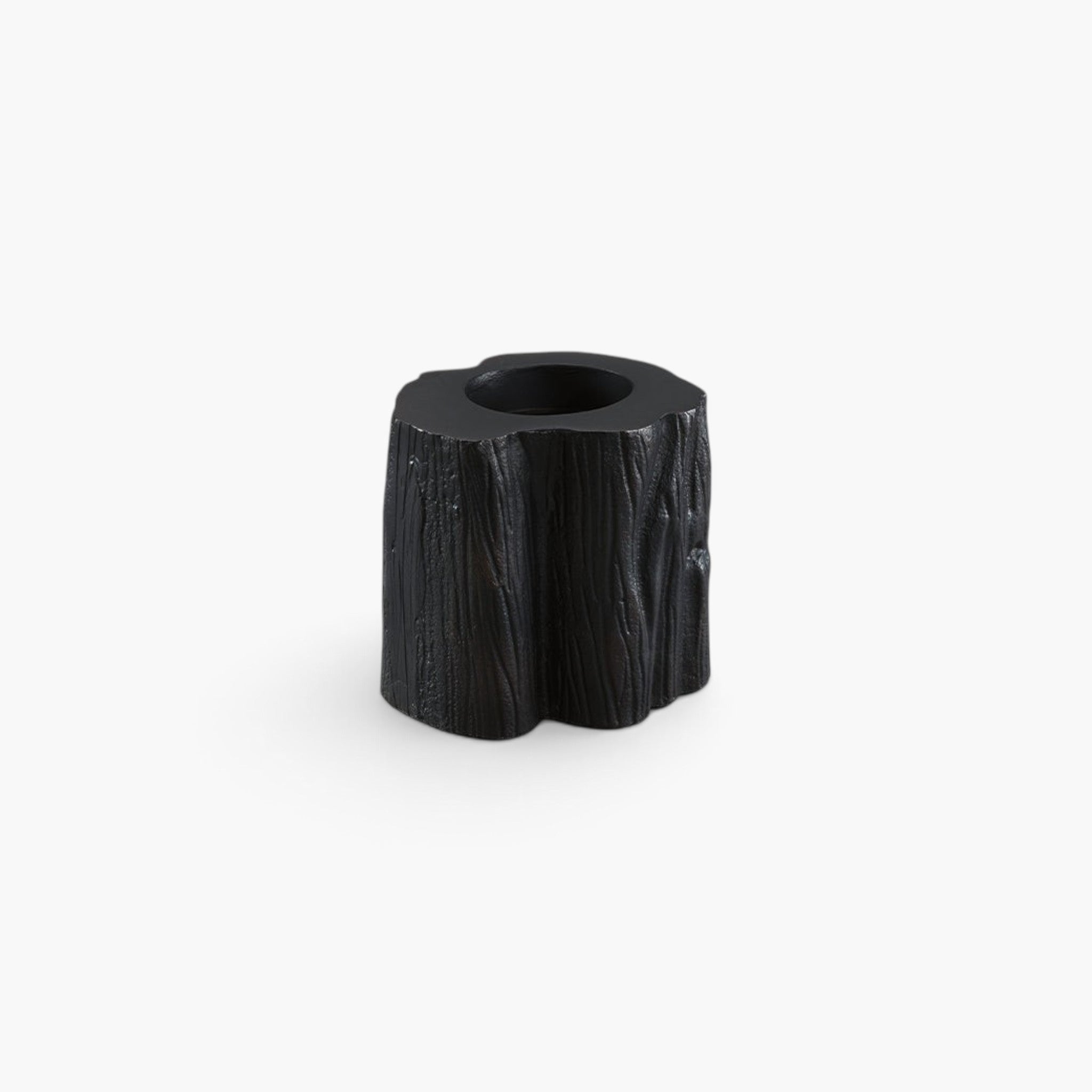 Lyckåsen Flame tealight candle holder in antique black metal with a textured wood grain design.