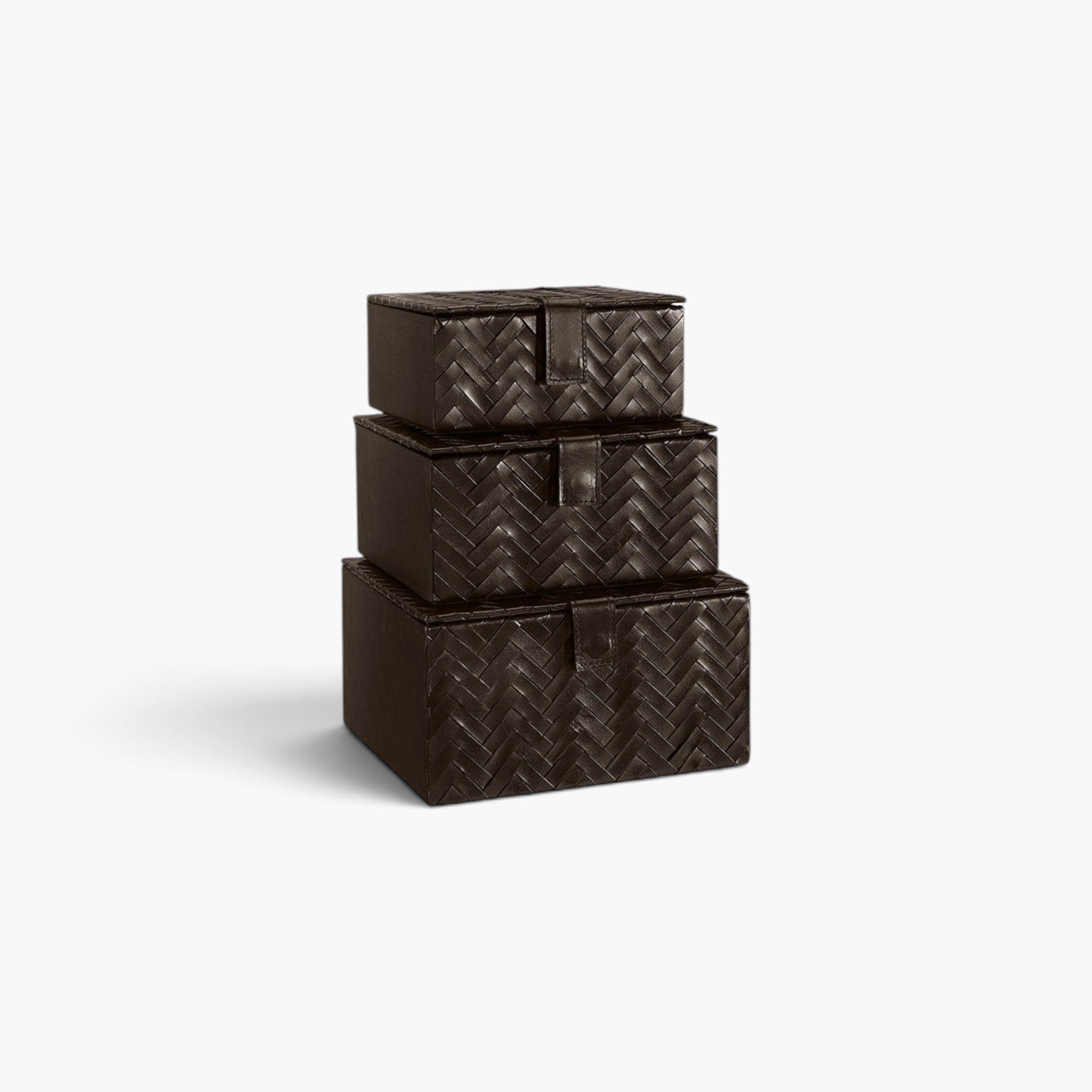 Lyckåsen Fontana 3-pack storage boxes in dark brown leather with a sophisticated herringbone pattern and snap closures.
