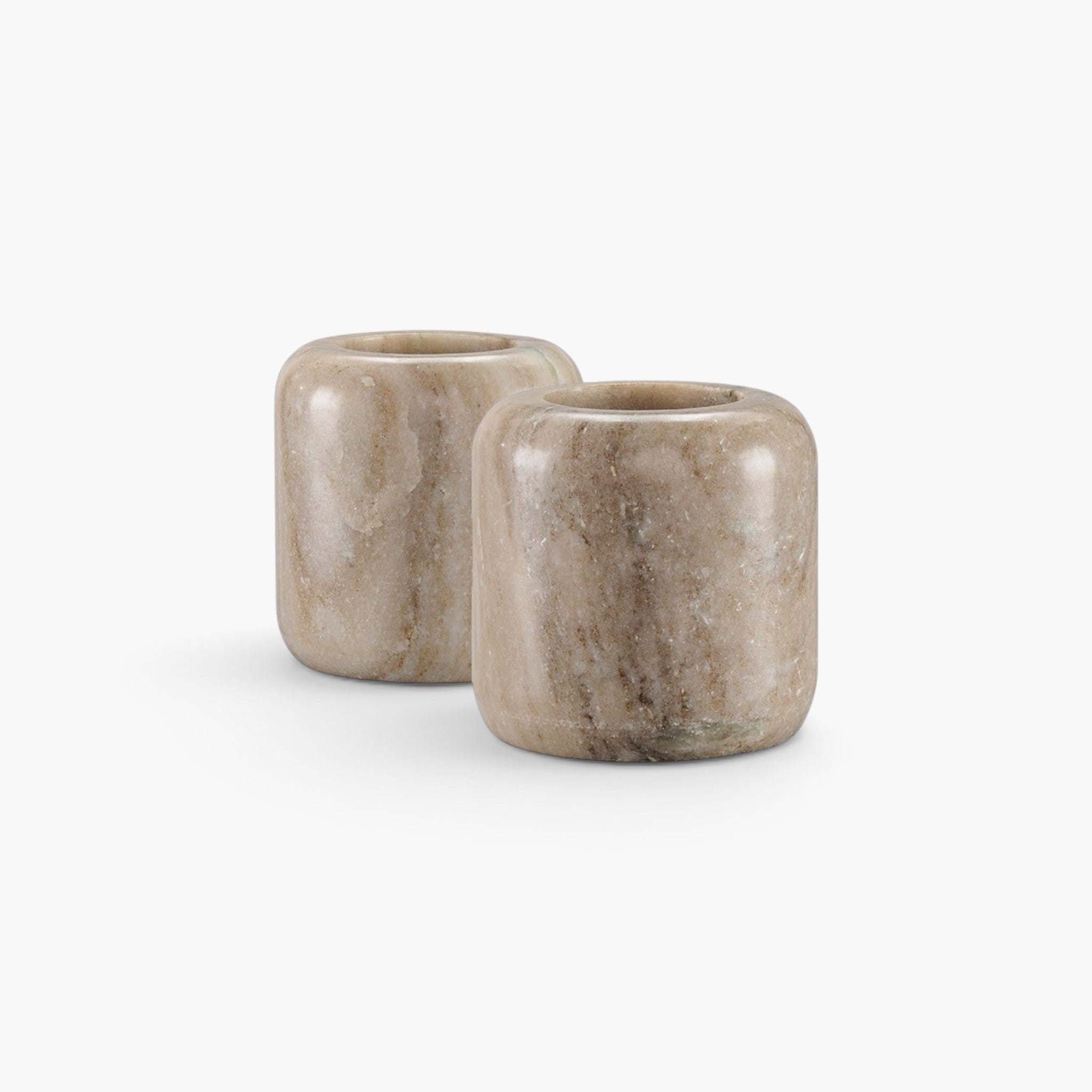 Lyckåsen Hera set of two beige marble candle holders with unique natural stone veining and a smooth cylindrical shape.