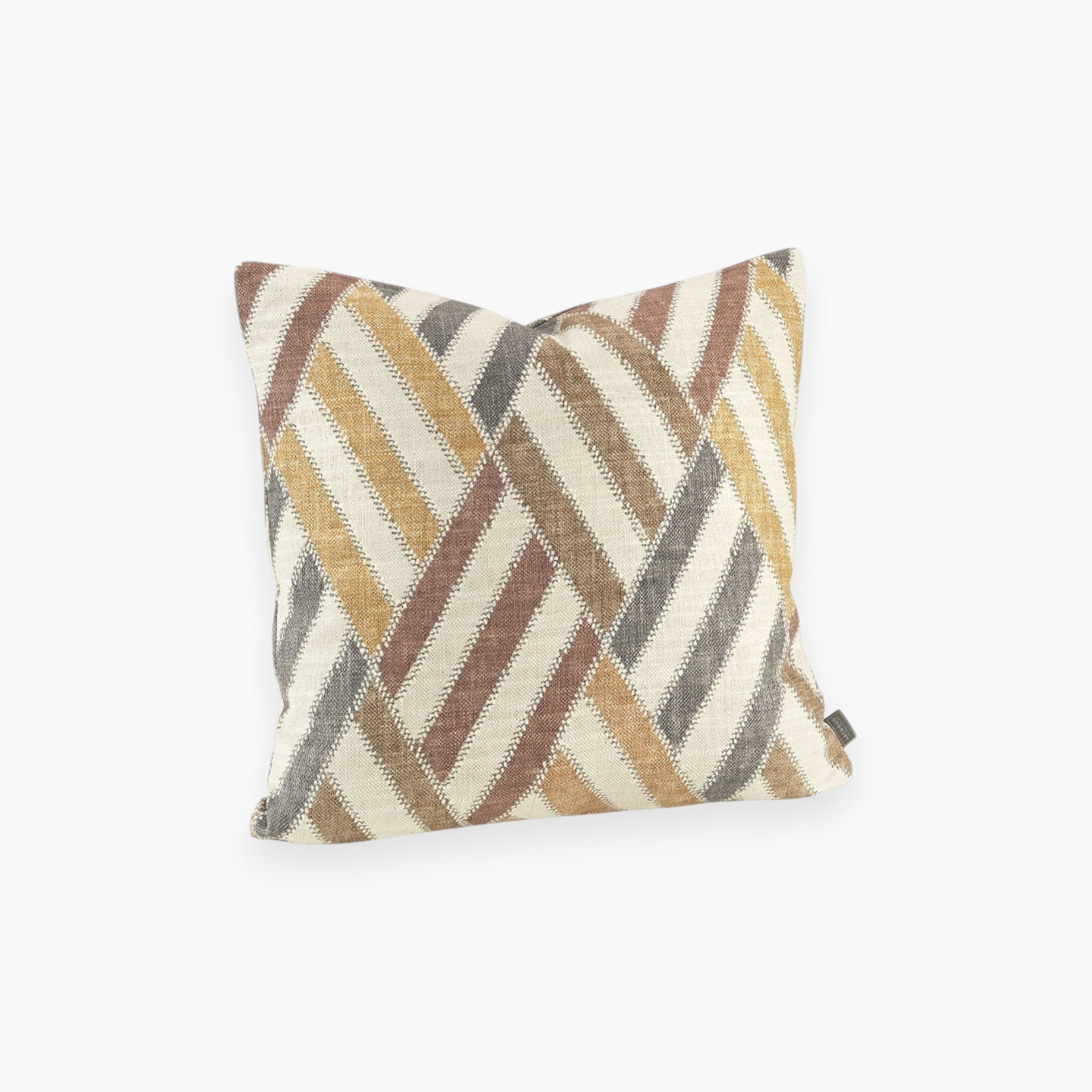 Lyckåsen Marrakech cushion cover with a graphic diagonal stripe pattern in rust, mustard, and grey on a natural base.