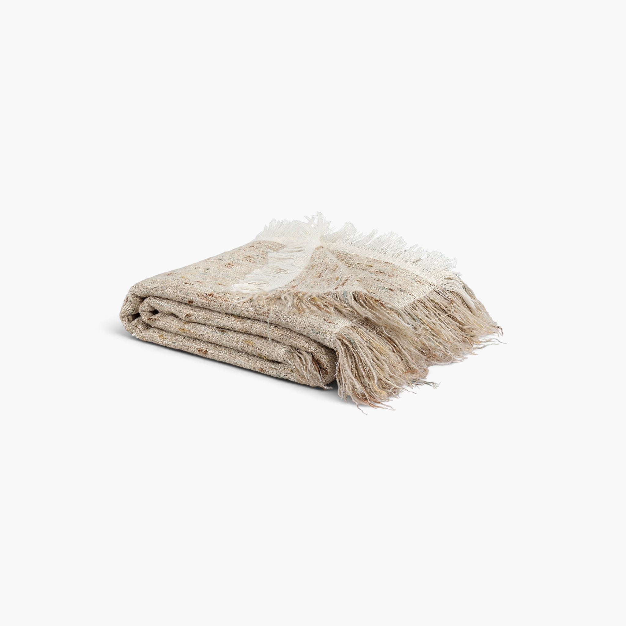 Lyckåsen Ventaro soft beige wool and linen blend throw blanket with textured mottled surface and long fringe edges.