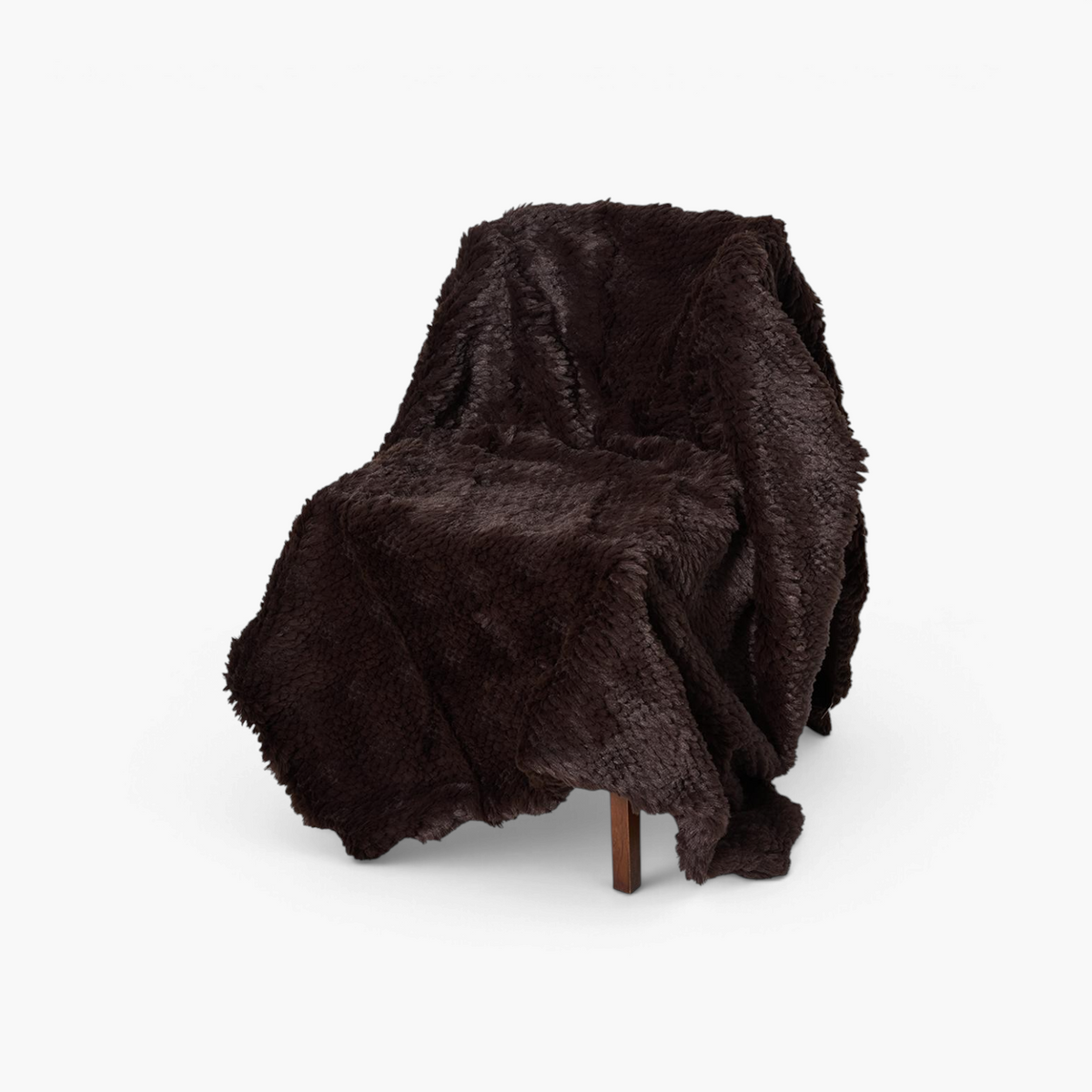 Lyckåsen Tuva brown polyester throw blanket with a soft, fluffy texture draped over a chair