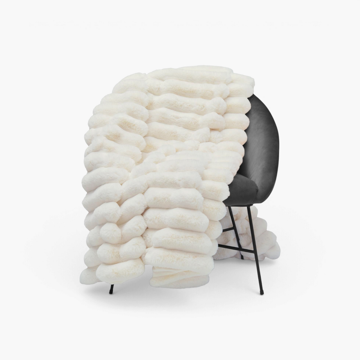 Lyckåsen Liny ivory polyester throw blanket with a soft textured striped pattern draped over a dark grey chair