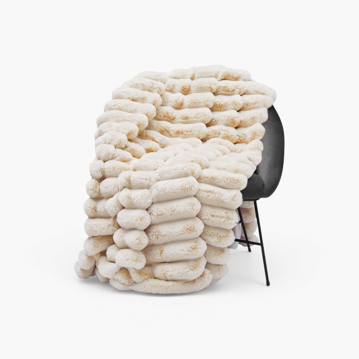 Lyckåsen Liny beige polyester throw blanket with a textured striped pattern draped over a modern chair