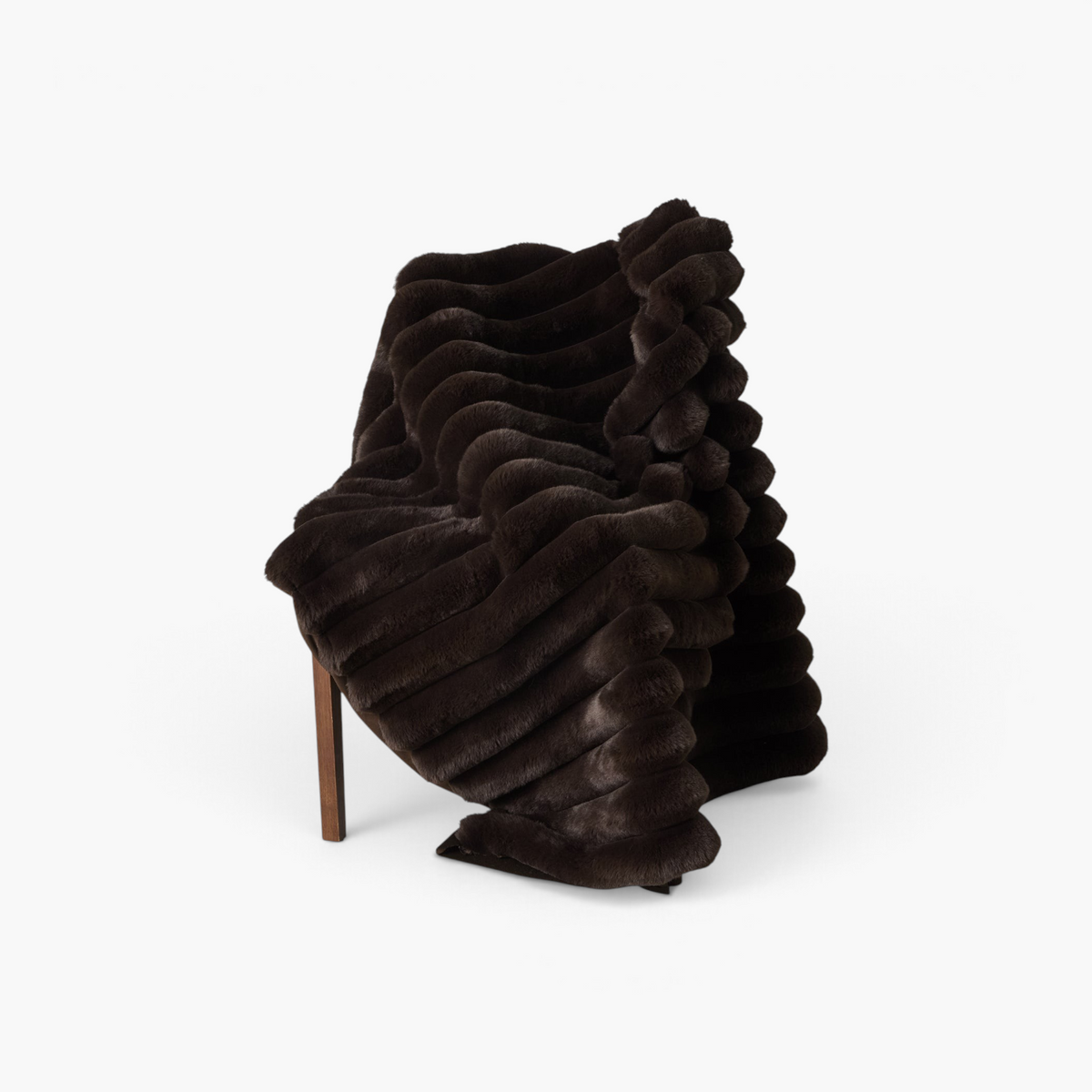 Lyckåsen Liny brown polyester throw blanket with wide stripes and soft plush backing draped over a chair