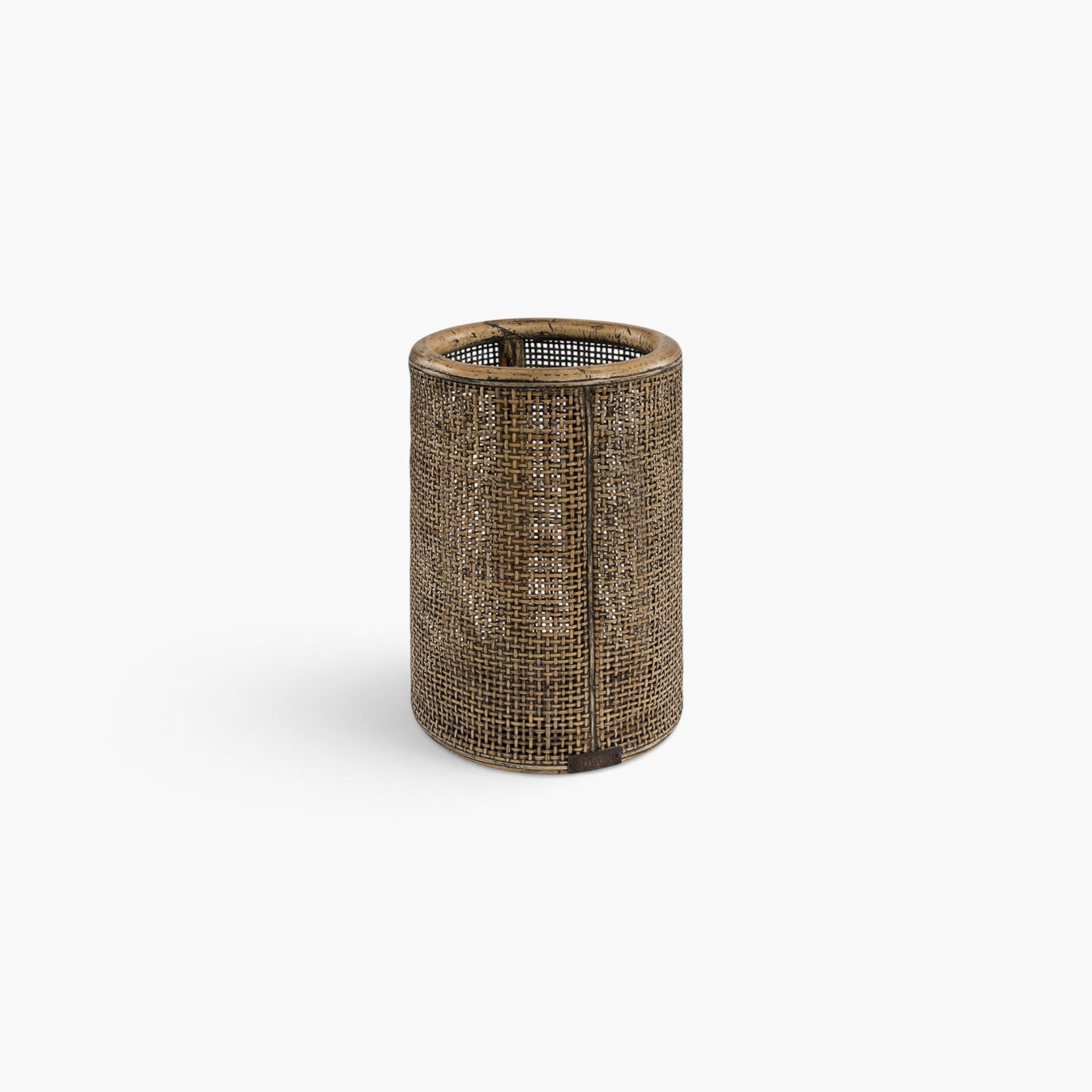 Lyckåsen Bayonne lantern made of woven brown bamboo with a cylindrical shape and a glass insert for a candle.