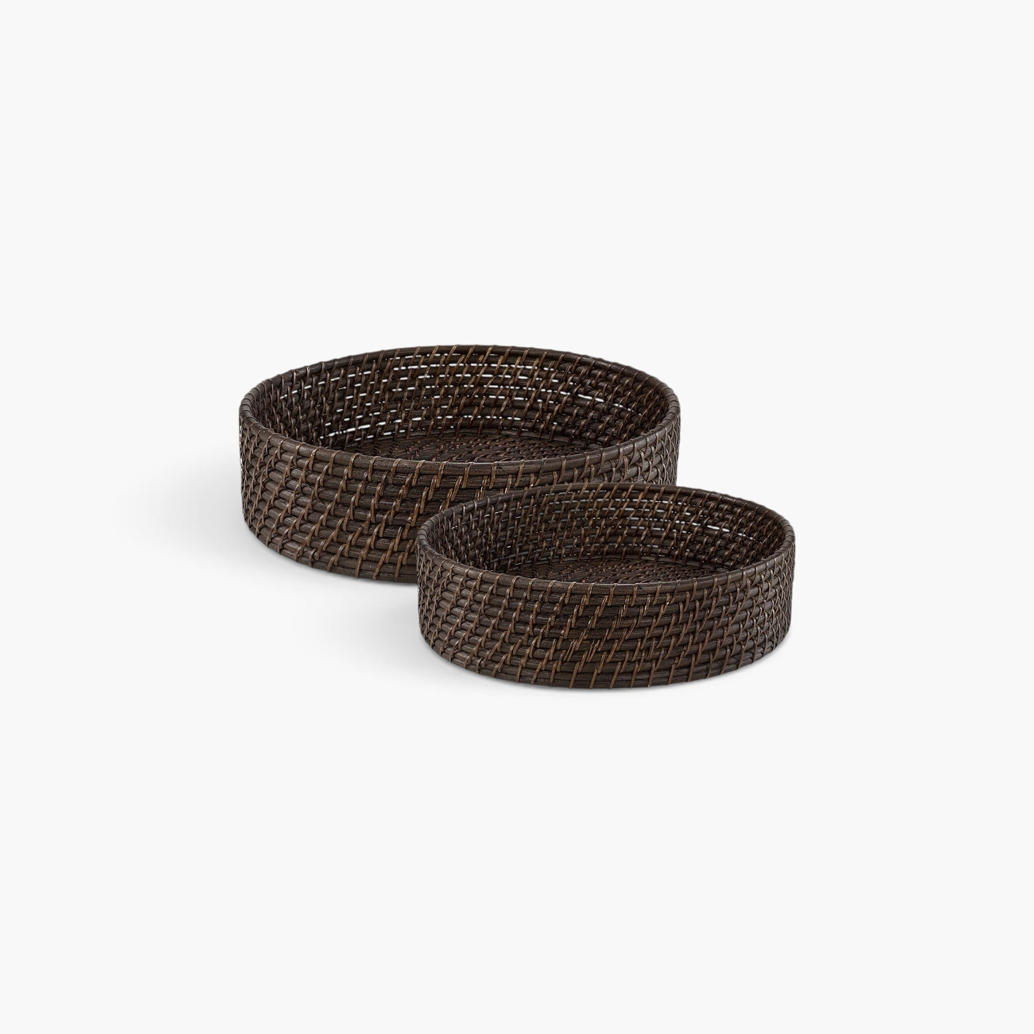 Lyckåsen set of two hand-woven deep brown rattan bread baskets for serving bread and pastries on a dining table.