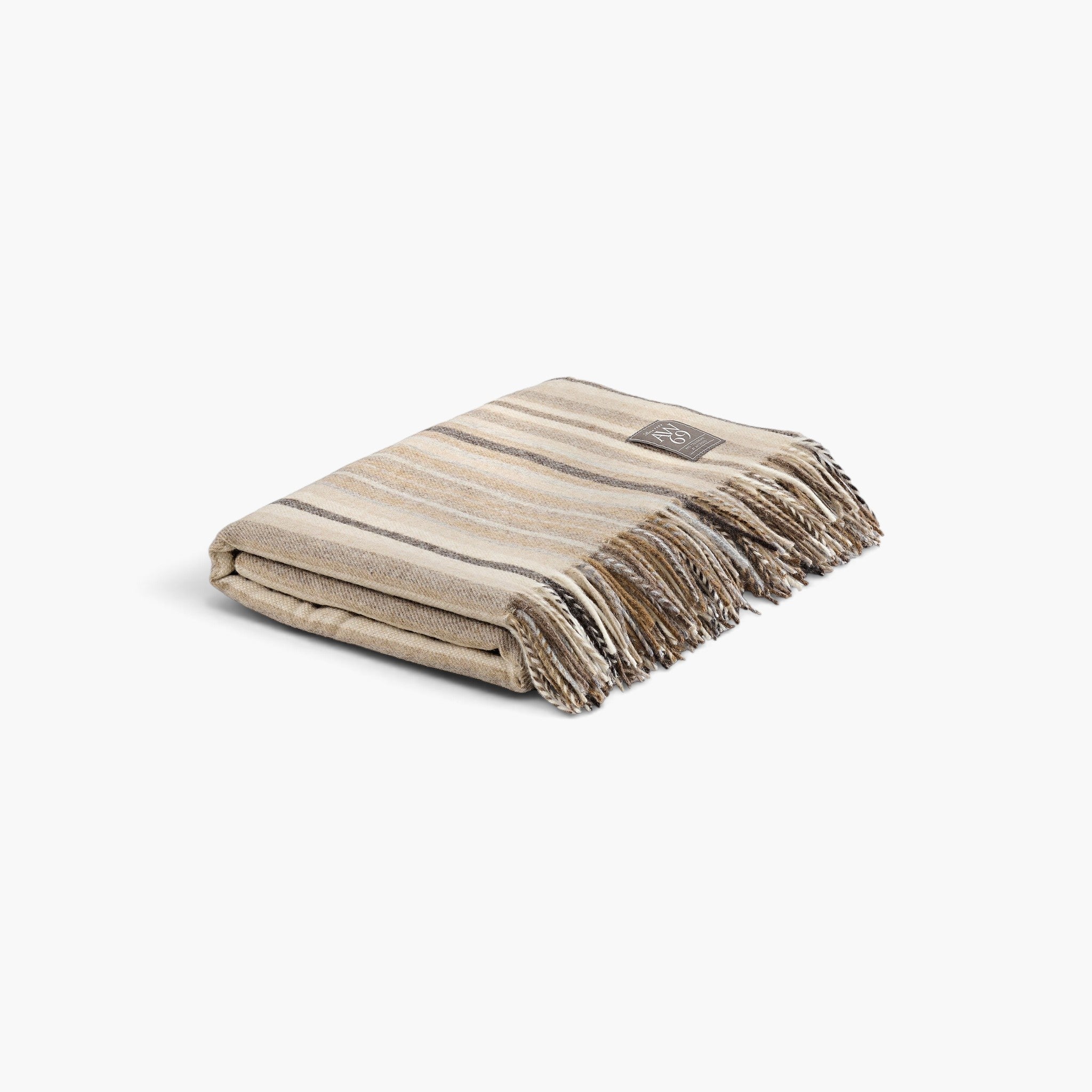 Lyckåsen Derby Stripe throw blanket in soft beige and brown merino wool with a classic striped pattern and fringe.