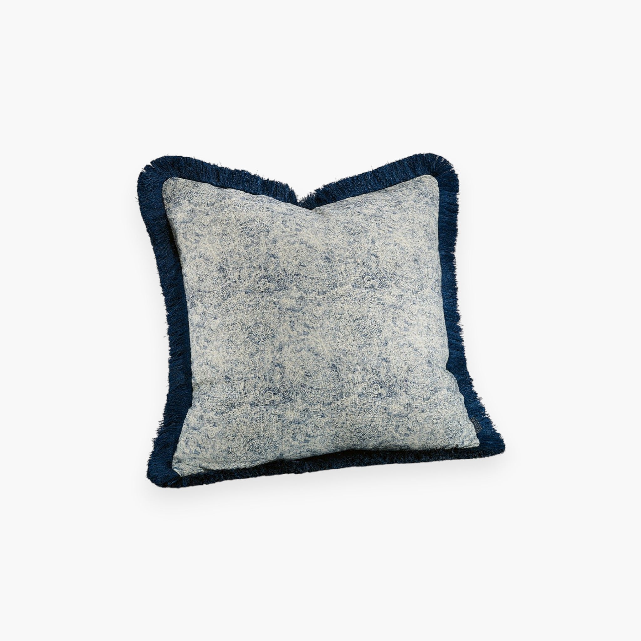Lyckåsen Easton indigo blue cotton and linen cushion cover with a subtle mottled pattern and decorative fringe trim.