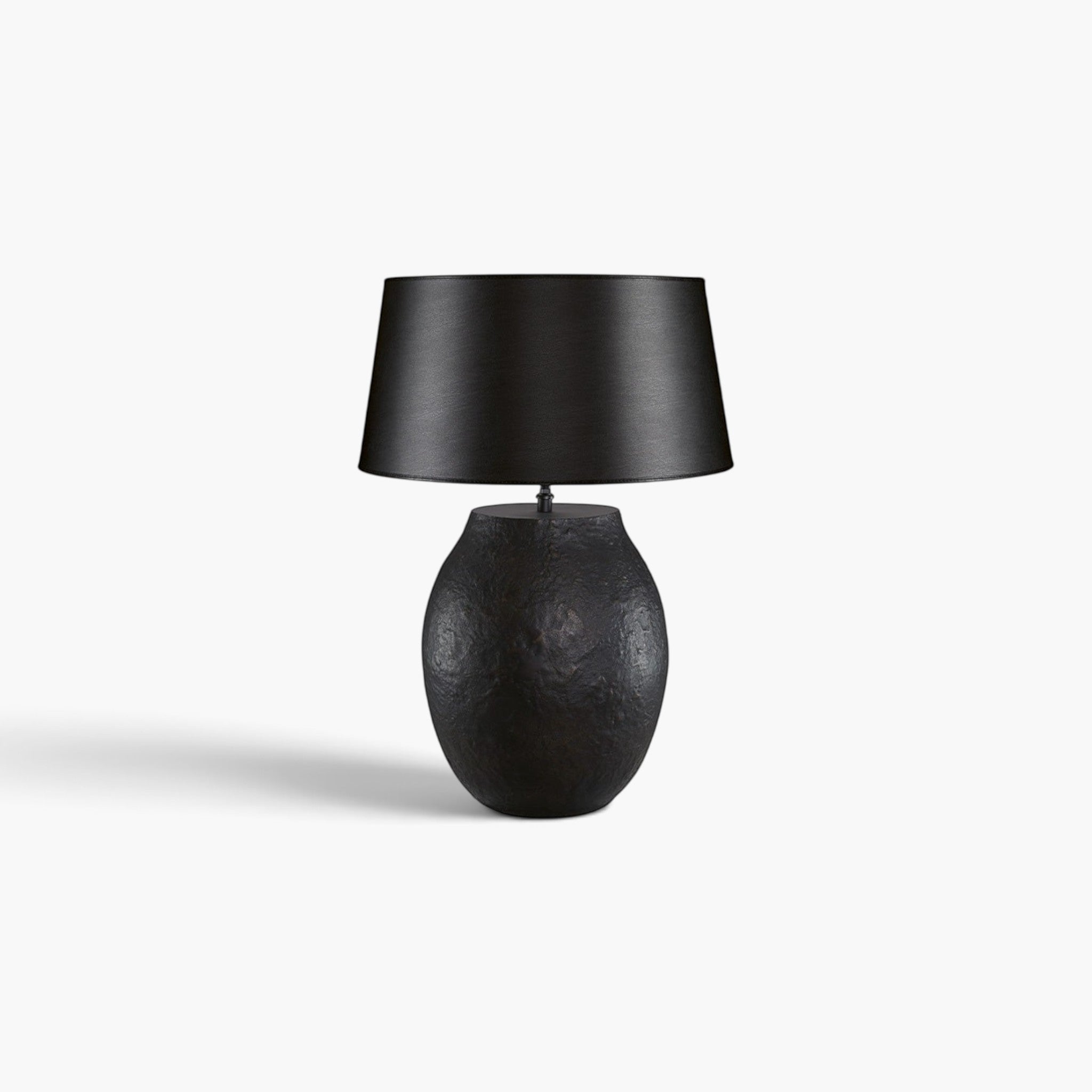 Lyckåsen Fiora table lamp in antique black and bronze metal with a textured finish and black fabric shade.