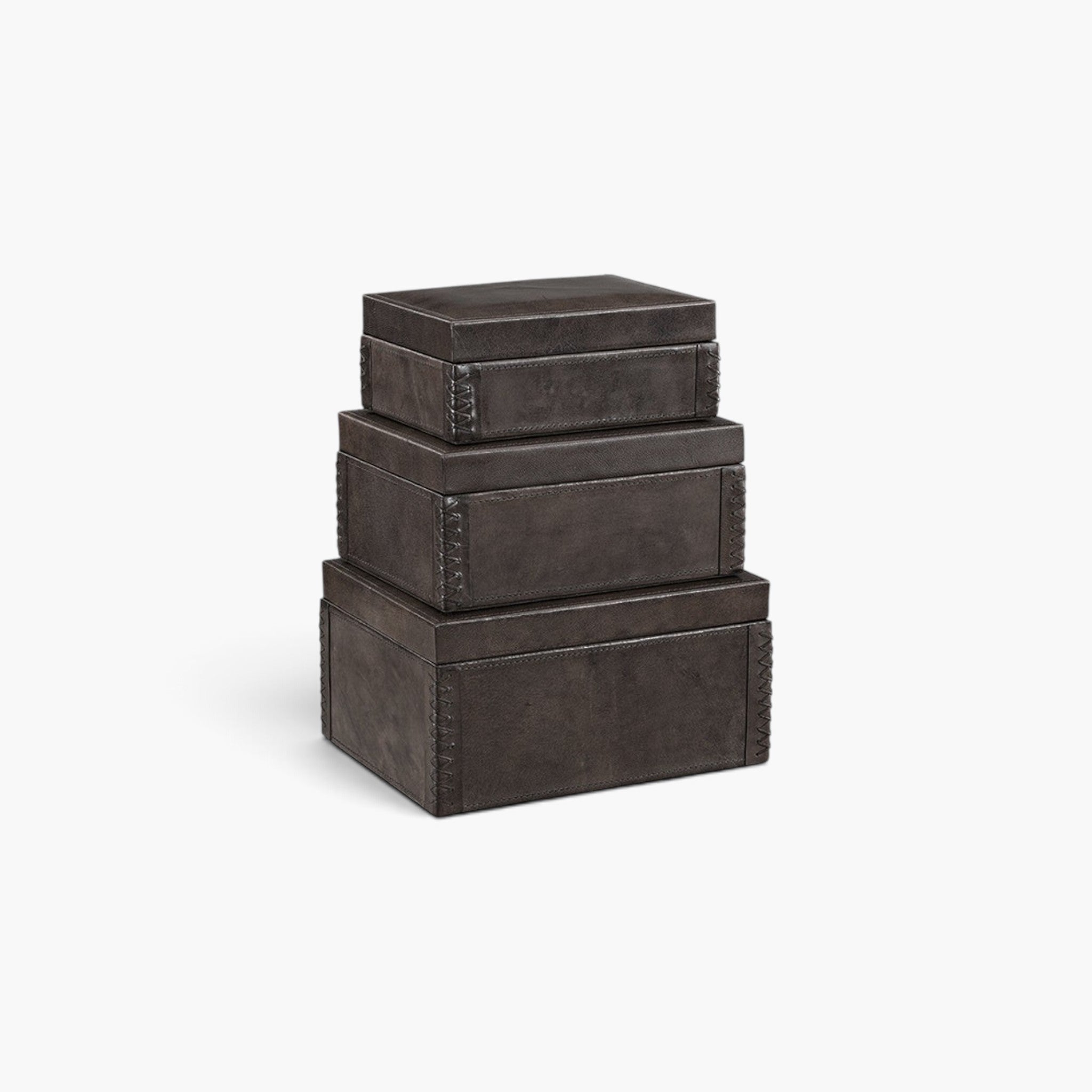 Lyckåsen Mendoza 3-pack dark brown leather storage boxes with stitched detailing stacked on a white background.
