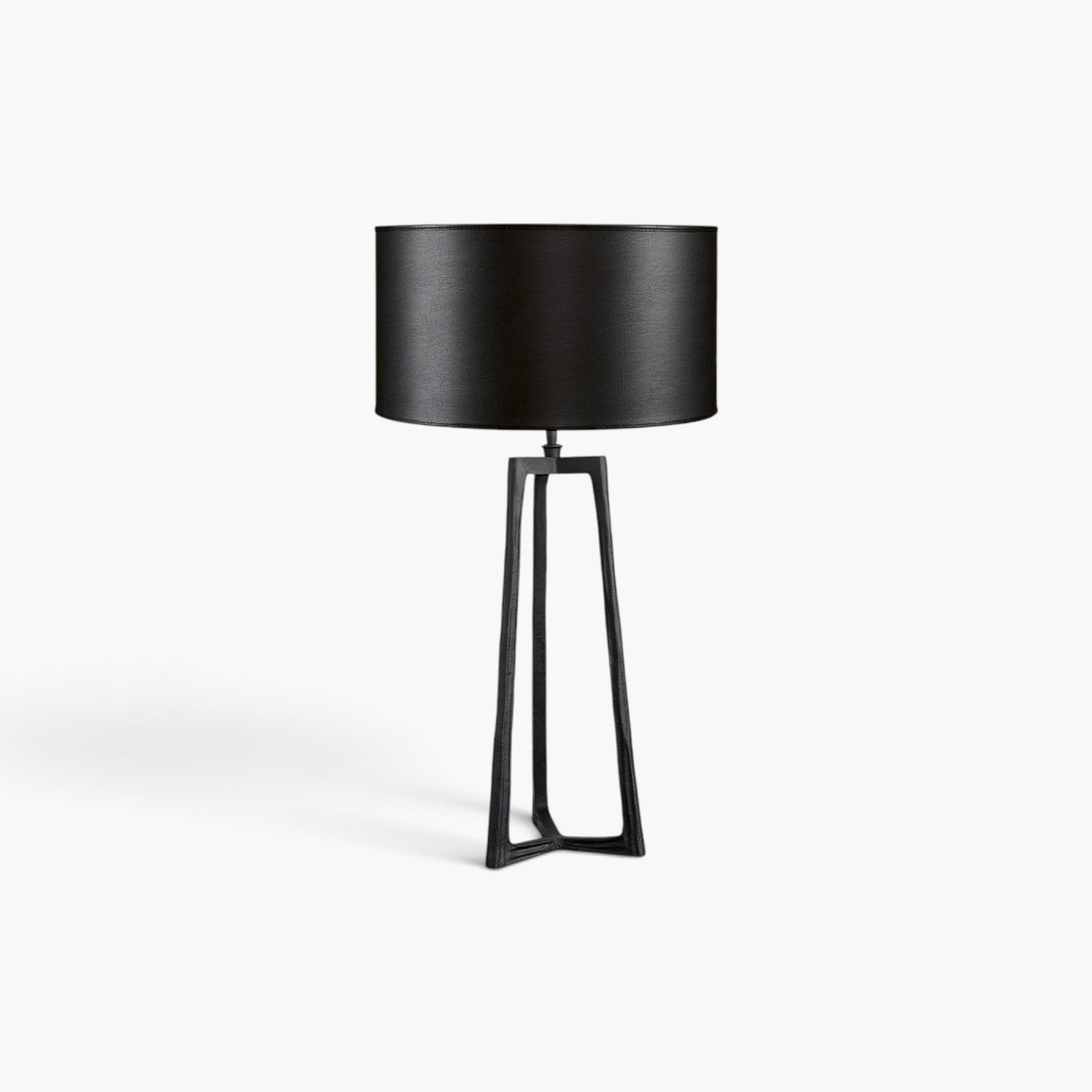 Lyckåsen Montone matte black metal tripod table lamp with a matching black drum shade on a white background.