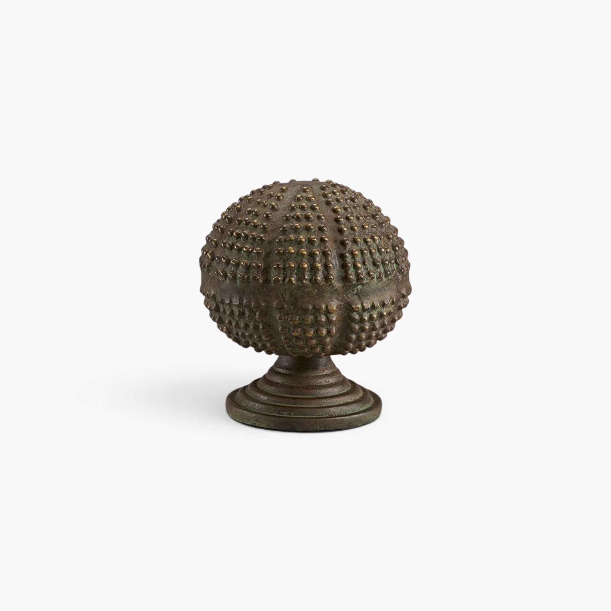 Lyckåsen Orba decorative metal object with a textured green patina finish in a sculptural spherical shape.