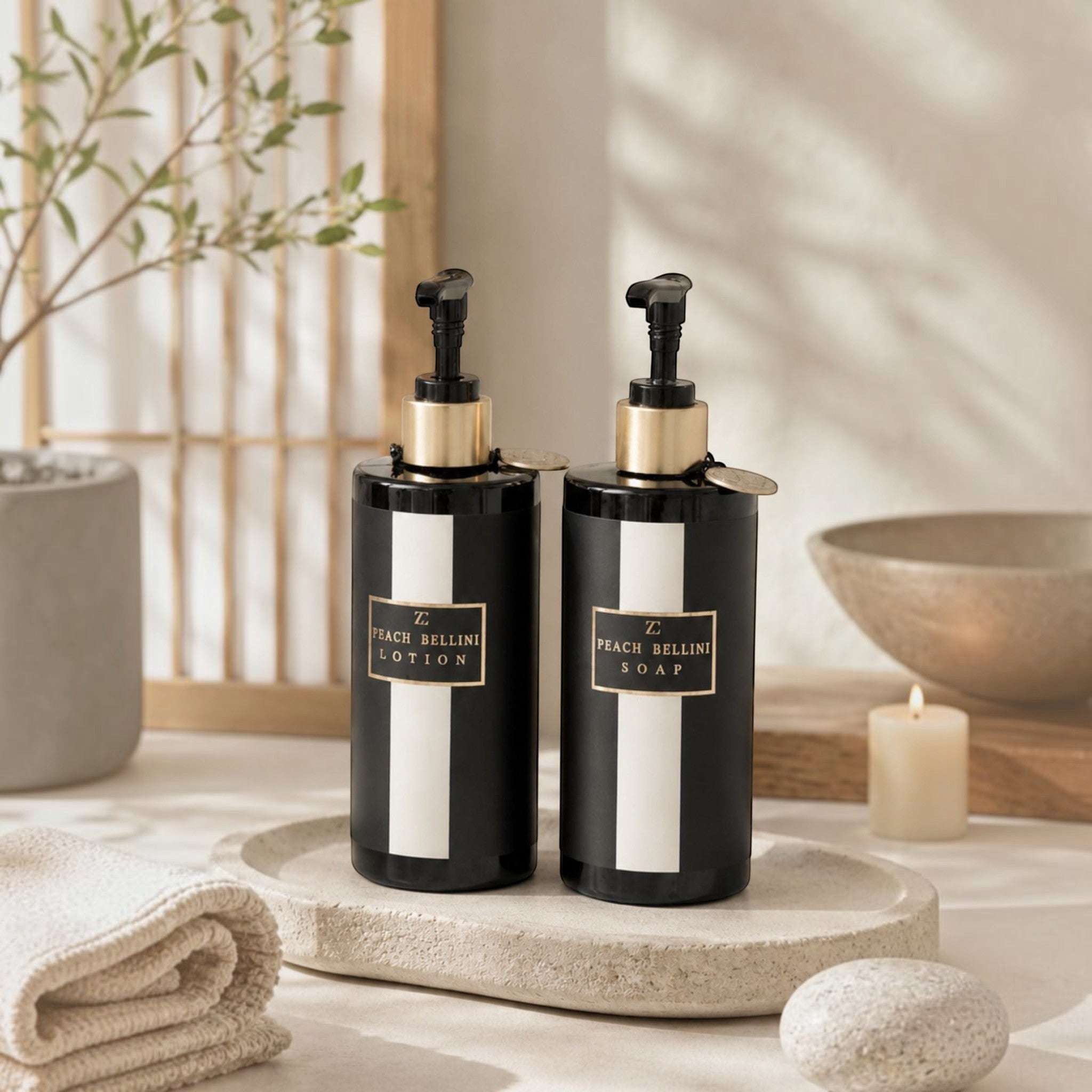 Lyckåsen Peach Bellini lotion and soap set in black bottles with gold pump dispensers on a stone tray.