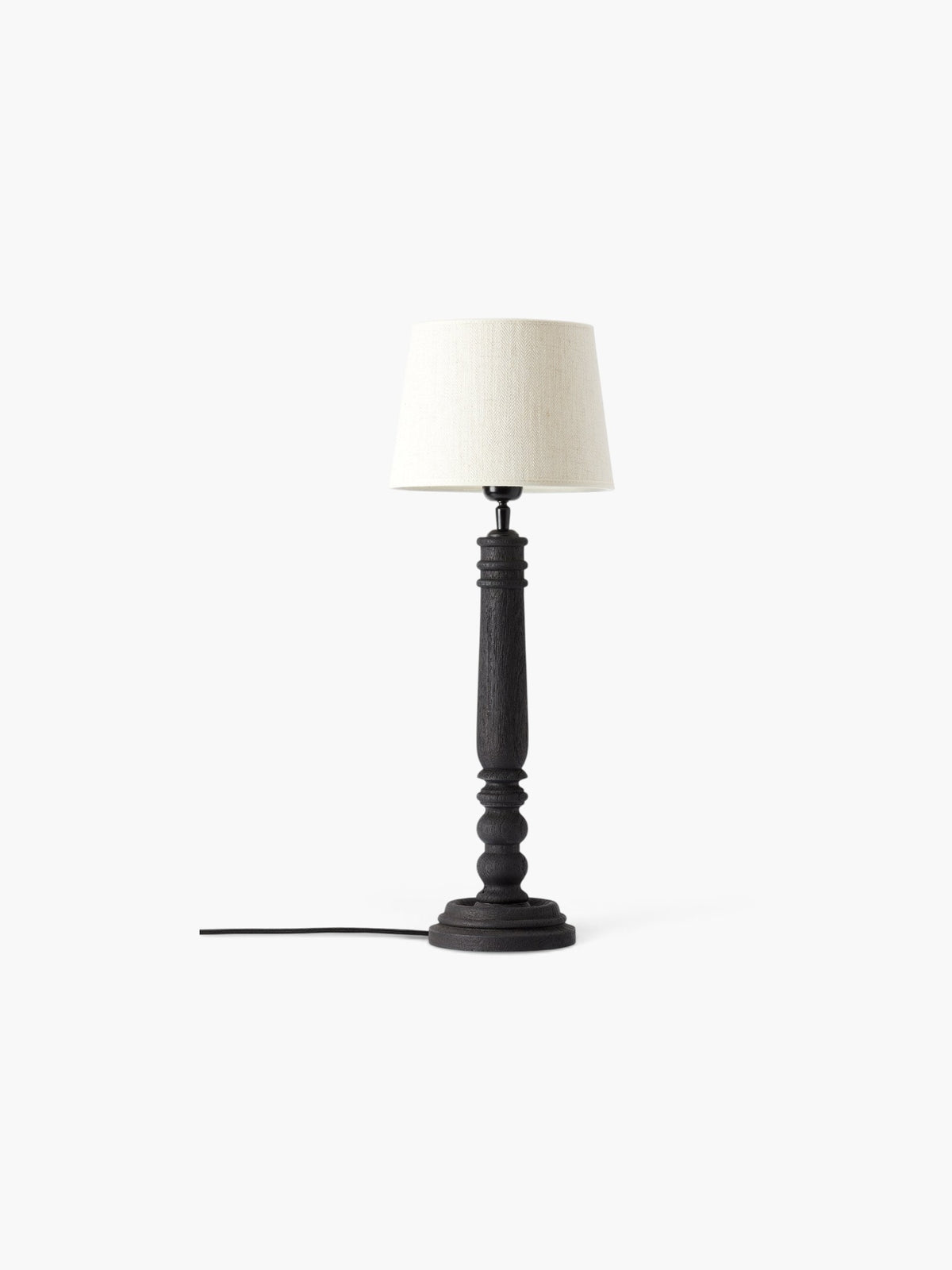 Lyckåsen Qvist 410 black turned wood table lamp with a sandblasted texture and a neutral fabric lampshade.