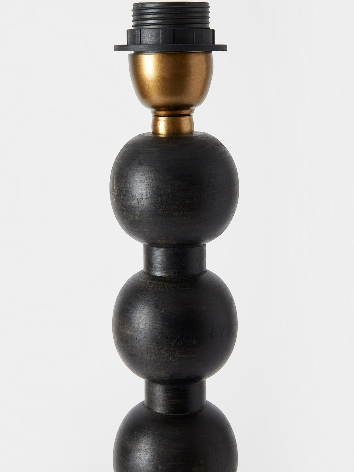 Lyckåsen Qvist 413 black wooden table lamp base with a stacked spherical design and brass socket detail.