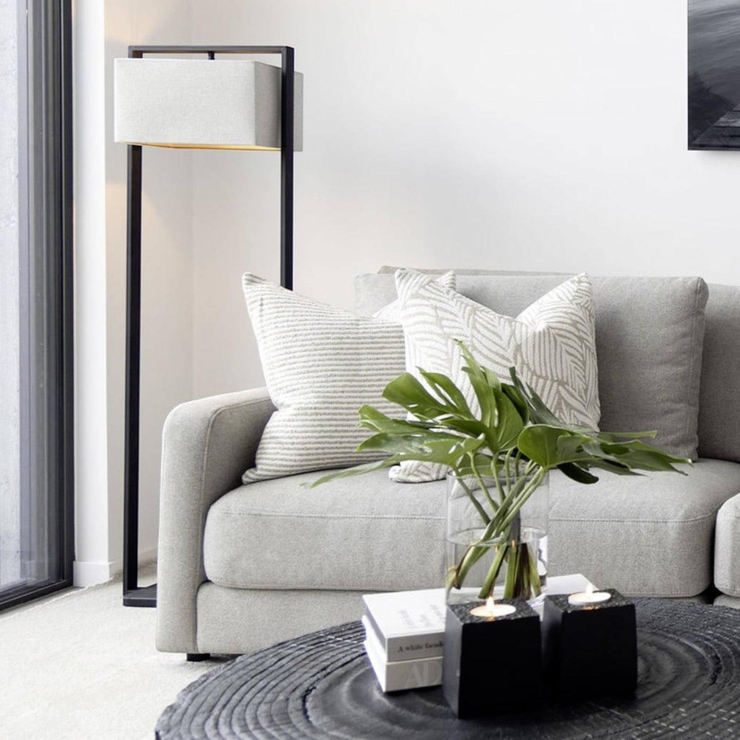 Lyckåsen rectangular natural fabric floor lamp shade on a black metal frame in a modern living room setting