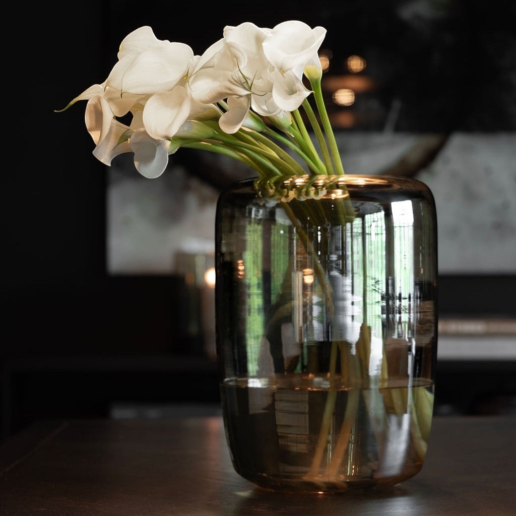 Lyckåsen Reef hand-blown glass vase in smoke brown with white flowers, featuring a unique cylindrical design.