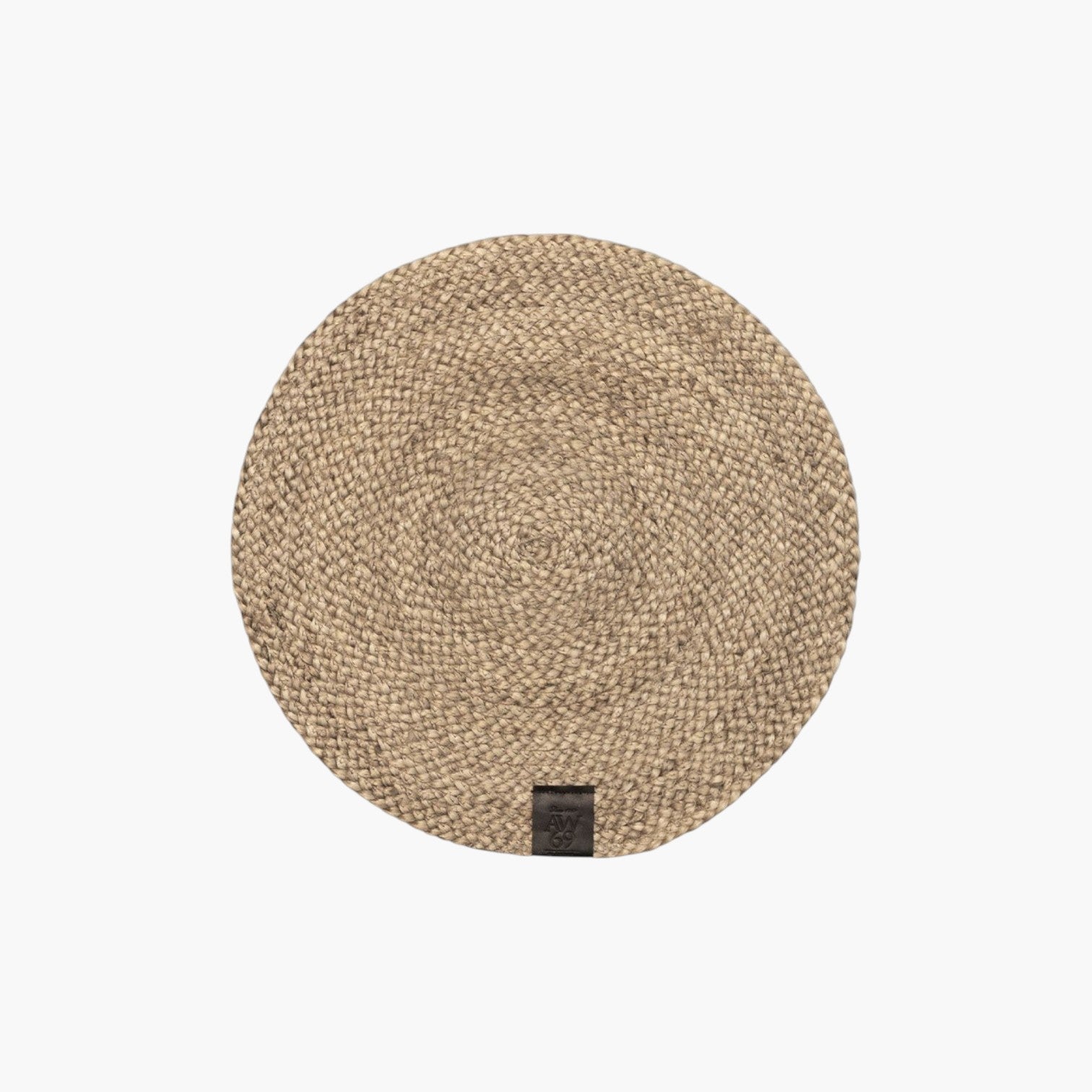 Lyckåsen round braided jute placemat in natural beige with a small dark leather brand tag