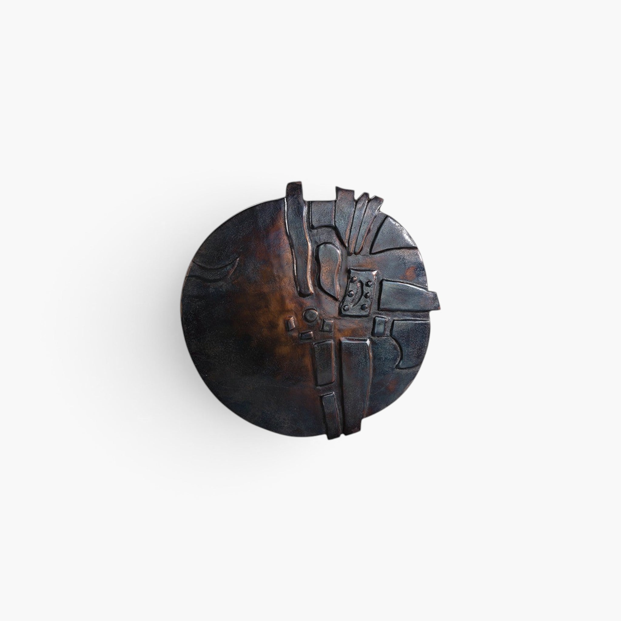 Lyckåsen round metal wall decoration in dark blue bronze with abstract textured geometric design.