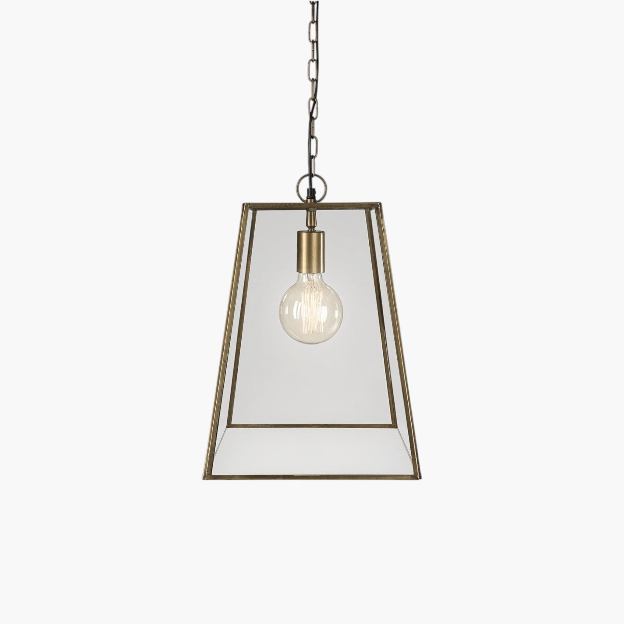 Lyckåsen Slim City Gold pendant lamp with a tapered glass shade and antique gold metal frame on a hanging chain.