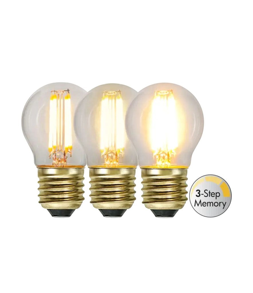 Lyckåsen Ljuskälla Small E27 LED bulb with 3-step dimming and warm 2100K light in a clear globe shape