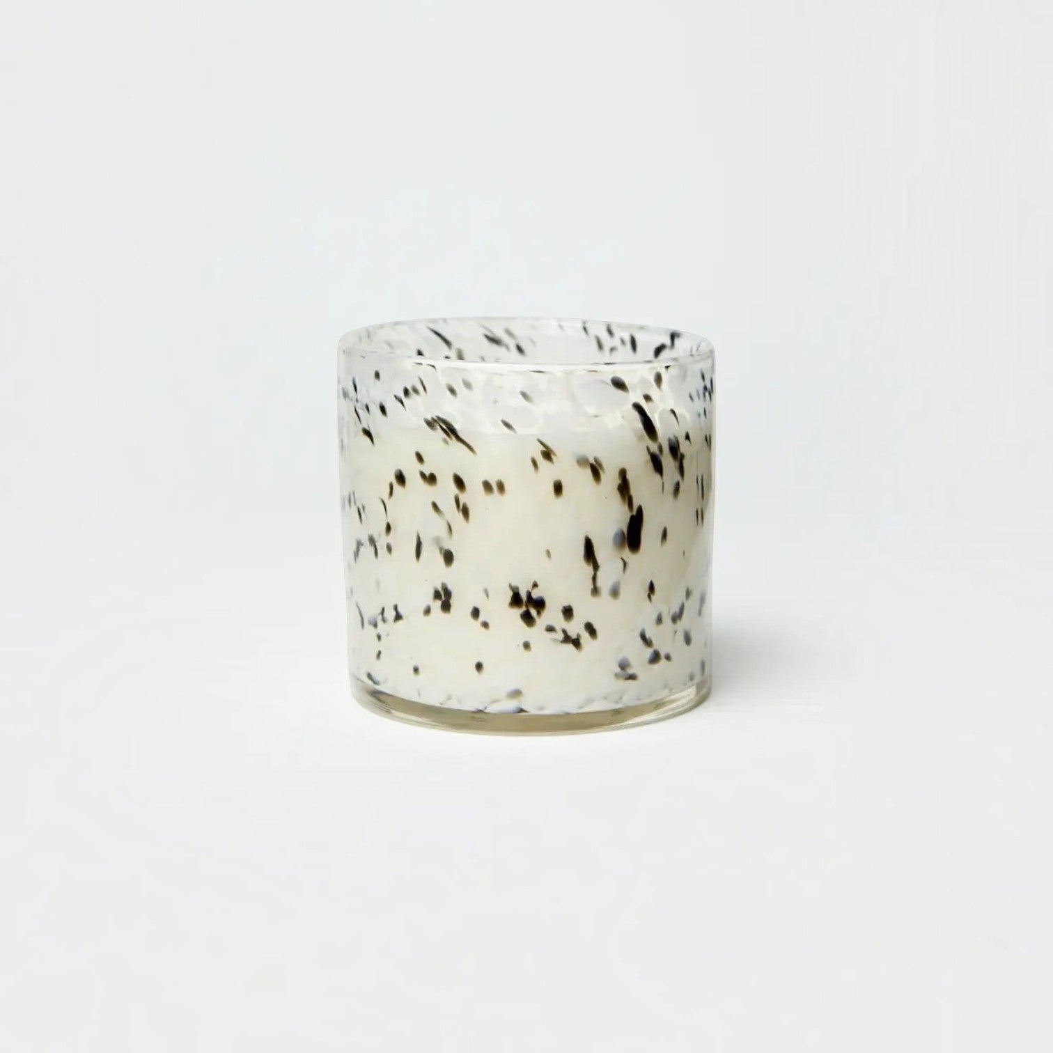 Lyckåsen Tokyo Seasalt Cassis scented candle in a hand-blown glass jar with a black and white speckled pattern.