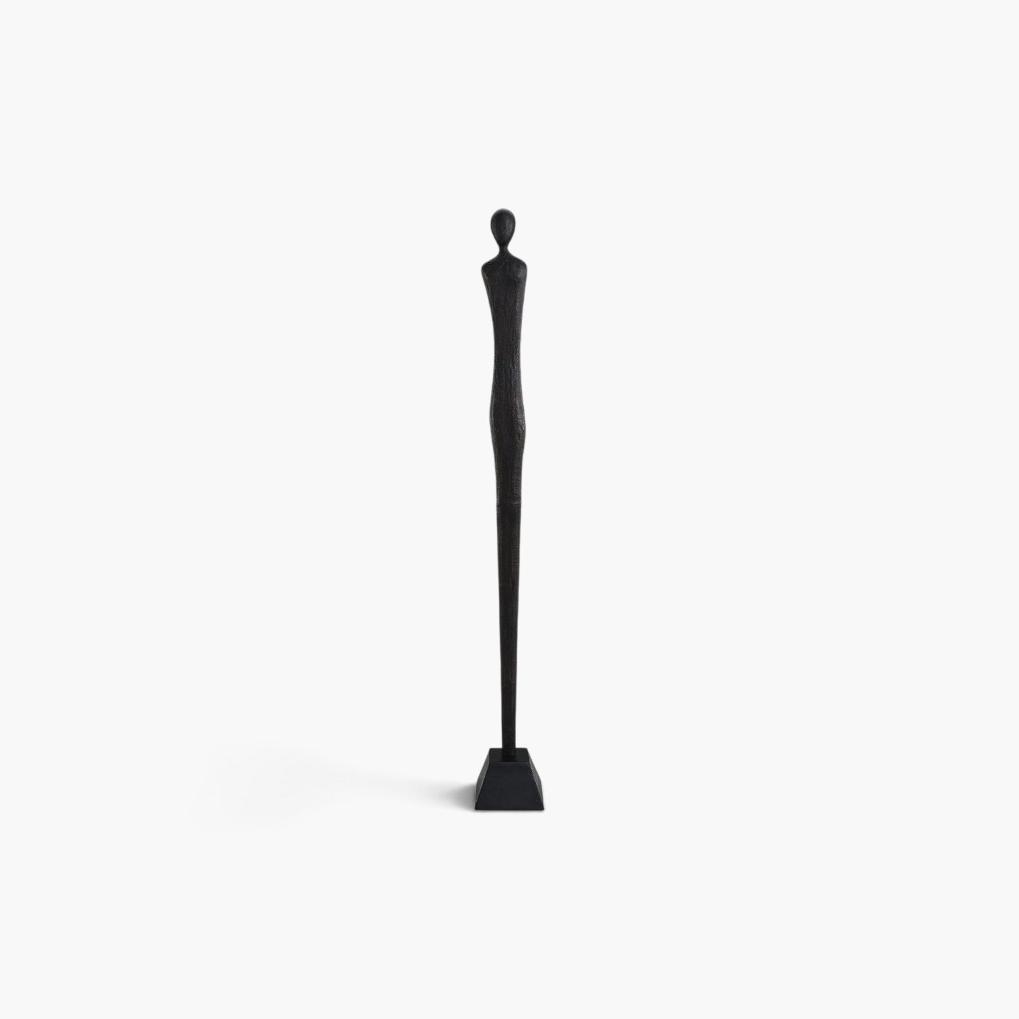 Lyckåsen Uomo minimalist floor statue of a man in matte antique black textured metal with a slender silhouette.
